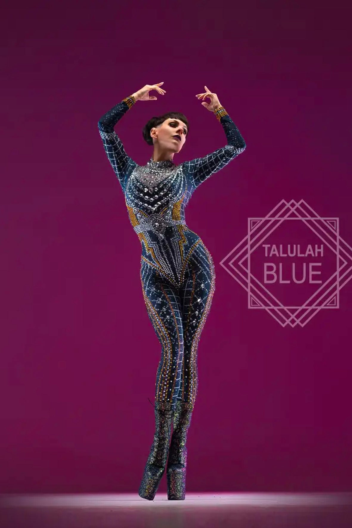 Dancer in a sparkling costume against a purple background with 'Talulah Blue' branding. Catsuit dance costume alien showgirl rockstar party