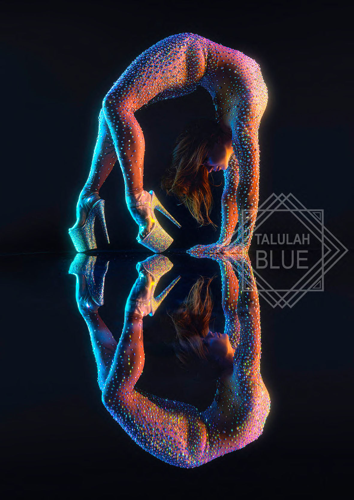 Colorful abstract figure with reflection on a black background, Talulah Blue logo visible. Anna by Andre Pattenden