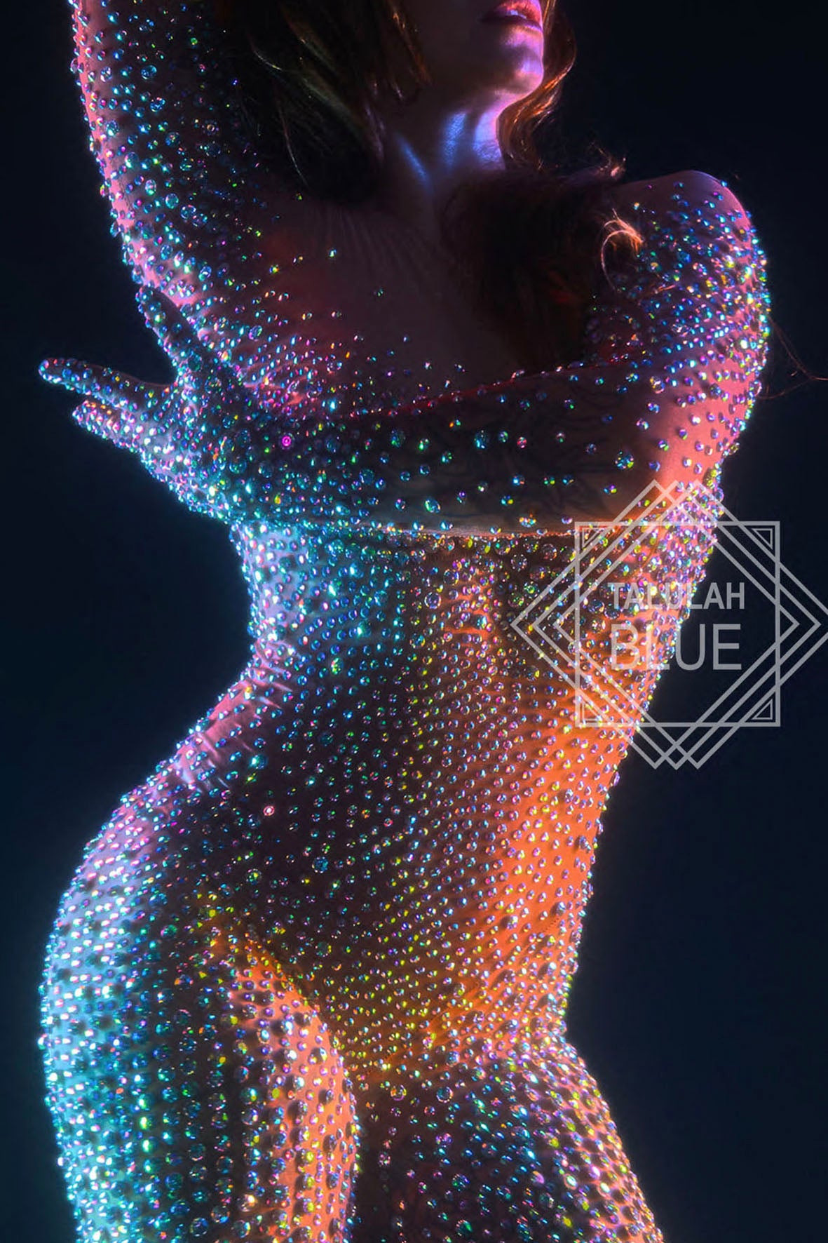 Artistic depiction of a figure covered in colourful beads against a dark background, with 'Talulah Blue' branding. Photo by Andre Pattenden Model Anna